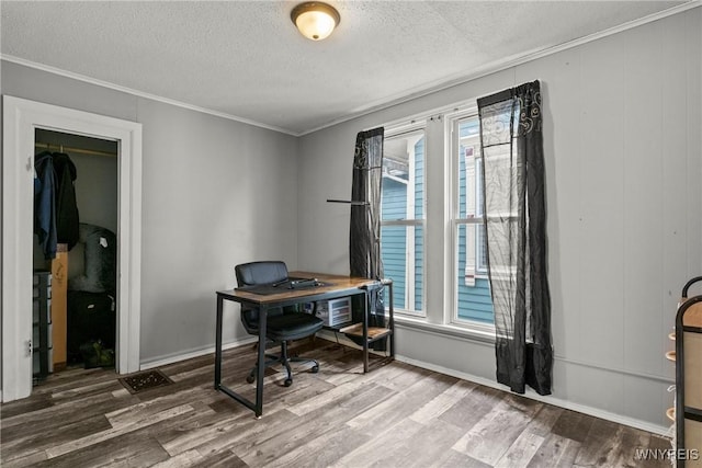 home office with a healthy amount of sunlight, ornamental molding, a textured ceiling, and wood finished floors