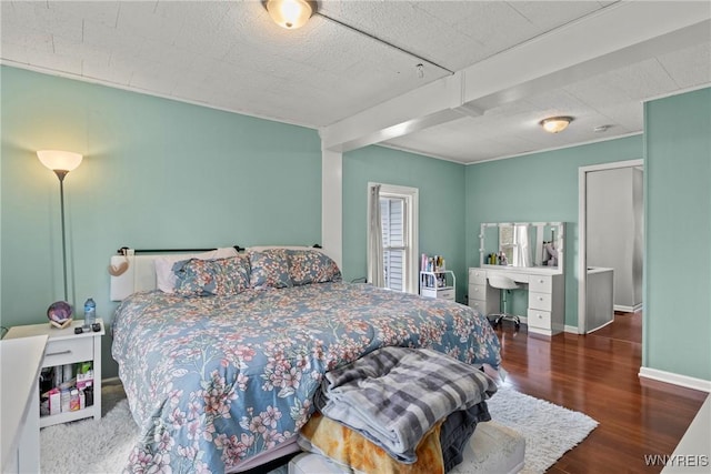 bedroom with baseboards and wood finished floors