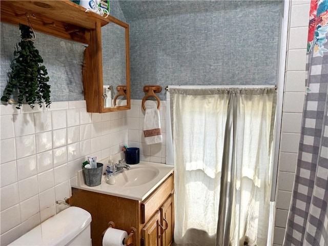 bathroom featuring vanity, decorative backsplash, toilet, and tile walls
