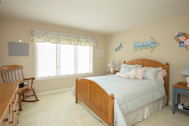 carpeted bedroom featuring baseboards