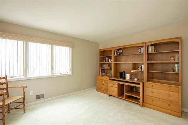 living area with light colored carpet, baseboards, and visible vents