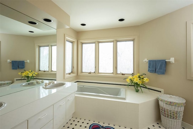 full bathroom with vanity and a garden tub