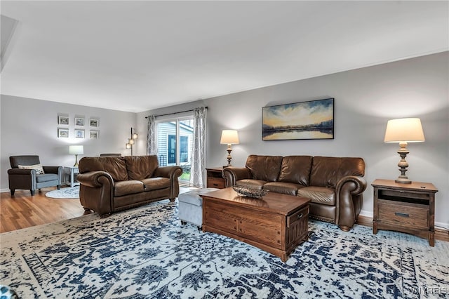 living area featuring baseboards and wood finished floors