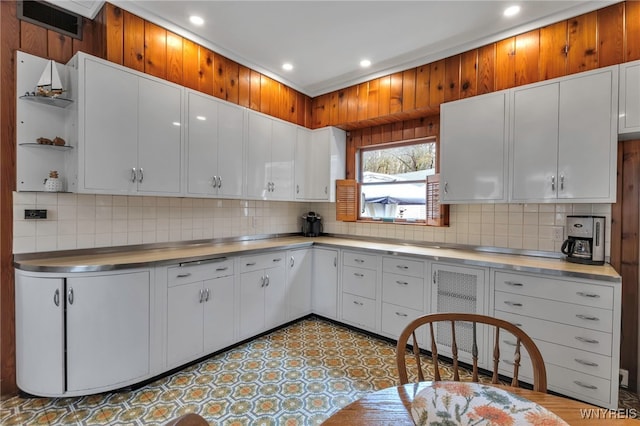 kitchen featuring stainless steel counters, backsplash, and recessed lighting