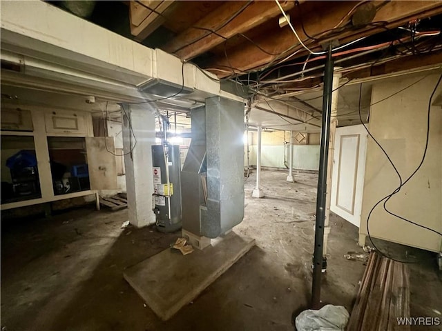 unfinished below grade area with heating unit and water heater