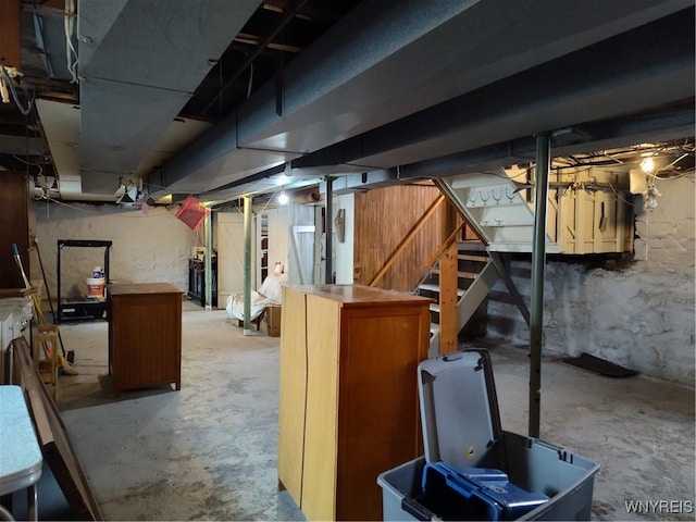 unfinished basement featuring stairs