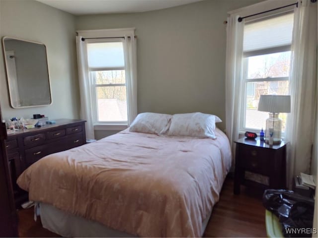 bedroom with dark wood-type flooring