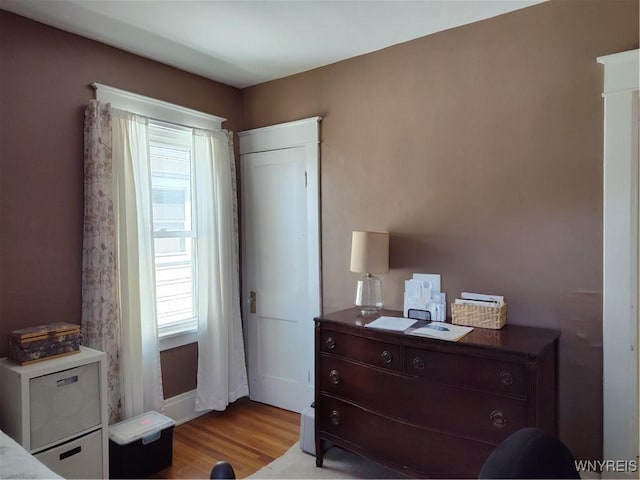 bedroom with baseboards and wood finished floors