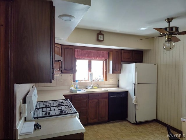 kitchen featuring white appliances, ceiling fan, light countertops, tasteful backsplash, and a sink