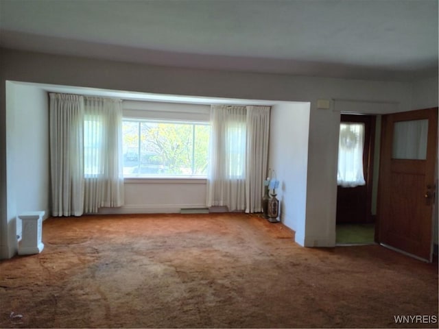 interior space with baseboards and carpet flooring
