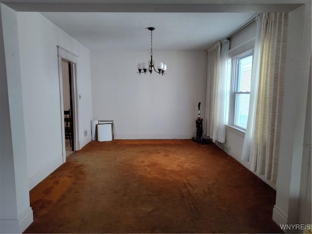 unfurnished dining area with an inviting chandelier, carpet floors, and baseboards