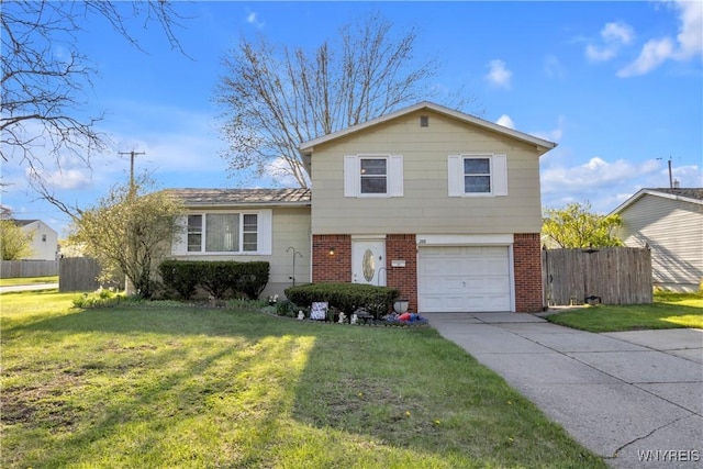 tri-level home featuring brick siding, a garage, a front lawn, and fence