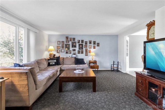 carpeted living area featuring baseboards