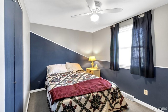 carpeted bedroom with baseboards, ceiling fan, and visible vents