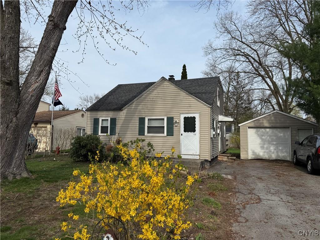 125 Maple Manor Dr, Clay, NY 13212 - exterior space with a garage, an outbuilding, driveway, and roof with shingles