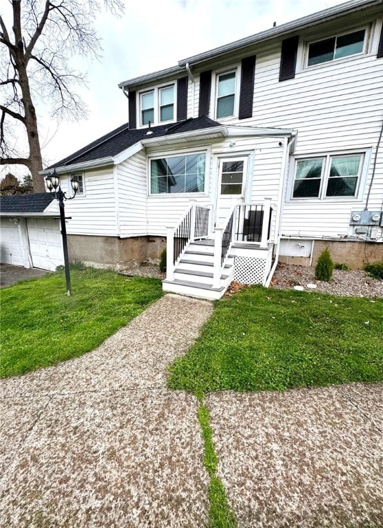 view of front facade with a garage and a front lawn