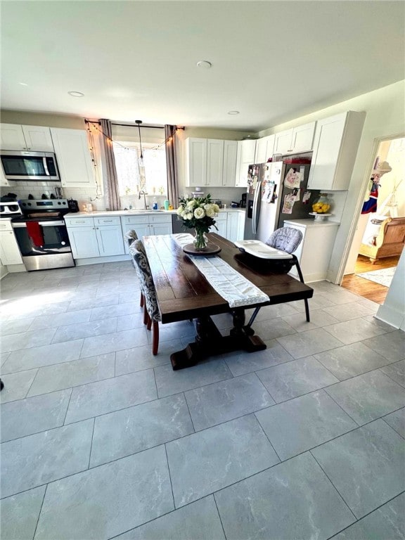 dining area featuring light tile patterned floors