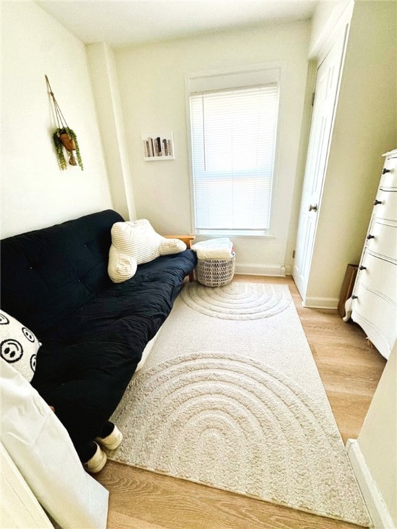 bedroom featuring baseboards and wood finished floors