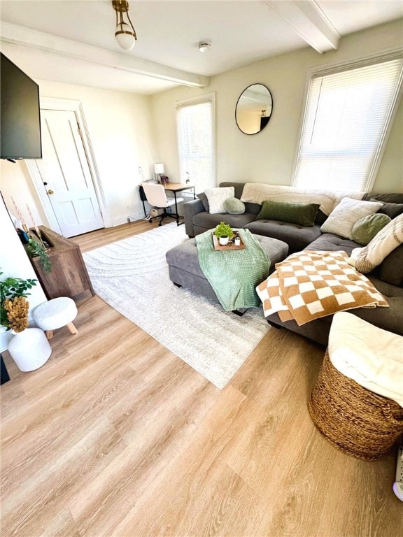 living room with beamed ceiling and wood finished floors