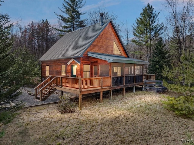 rear view of property featuring metal roof