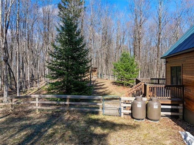 view of yard featuring fence and a wooden deck