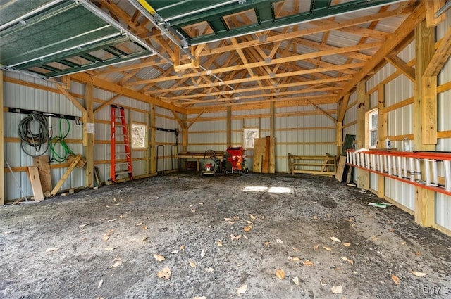 misc room with metal wall, lofted ceiling, and a garage
