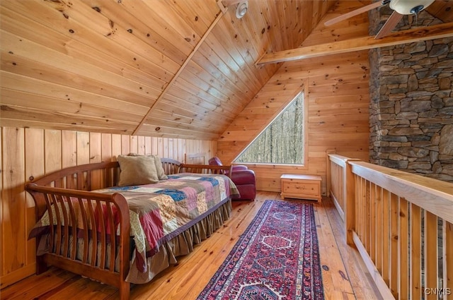 bedroom featuring light wood-style floors, lofted ceiling, wooden walls, and wooden ceiling