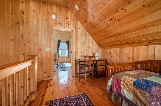 bedroom featuring wood ceiling, wood-type flooring, vaulted ceiling, and wood walls
