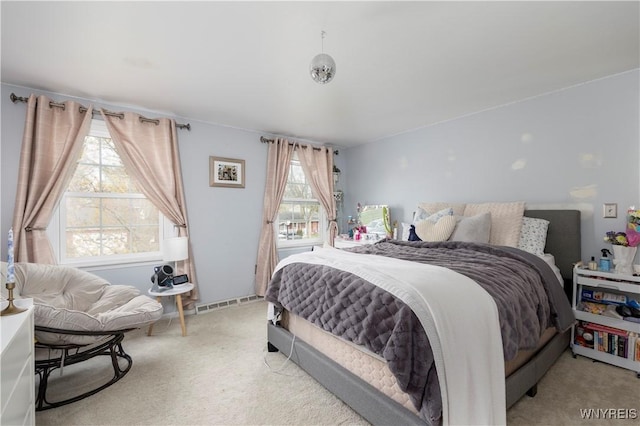 carpeted bedroom featuring visible vents