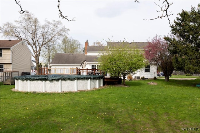 exterior space featuring a wooden deck and a covered pool