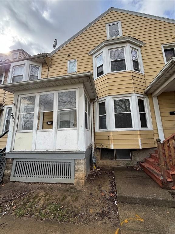 townhome / multi-family property with a sunroom