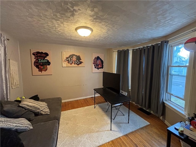 living room with baseboards and wood finished floors
