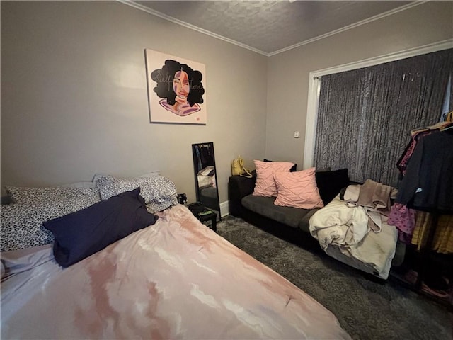 bedroom with crown molding, baseboards, carpet, and a closet