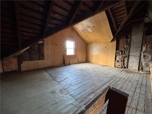 interior space featuring wooden walls, wooden ceiling, and vaulted ceiling