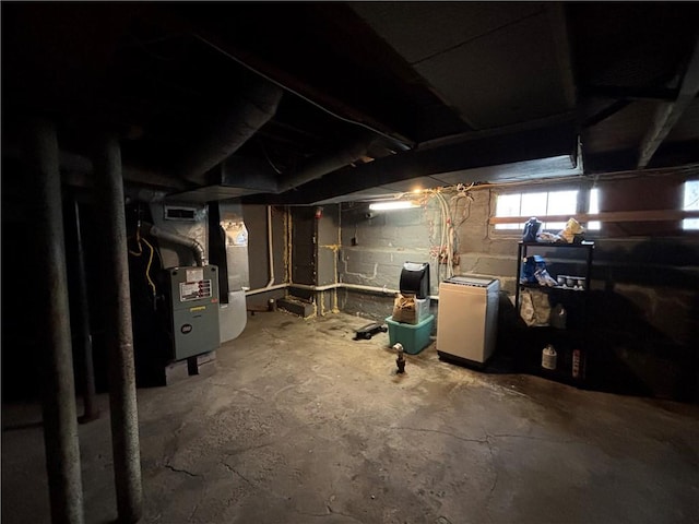 basement with heating unit and fridge