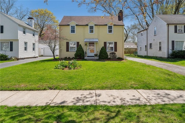 colonial house with a front lawn and a chimney