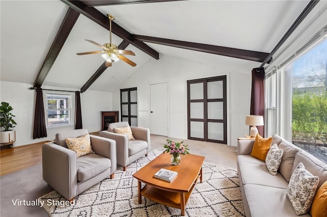 living room featuring vaulted ceiling with beams and a ceiling fan