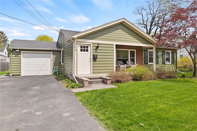 single story home featuring an attached garage, a front lawn, aphalt driveway, and roof with shingles
