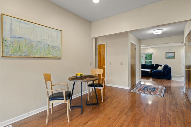 dining room with baseboards and wood finished floors