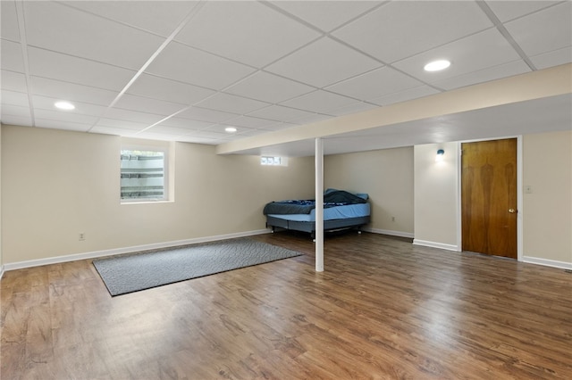 bedroom featuring baseboards, a drop ceiling, recessed lighting, and wood finished floors