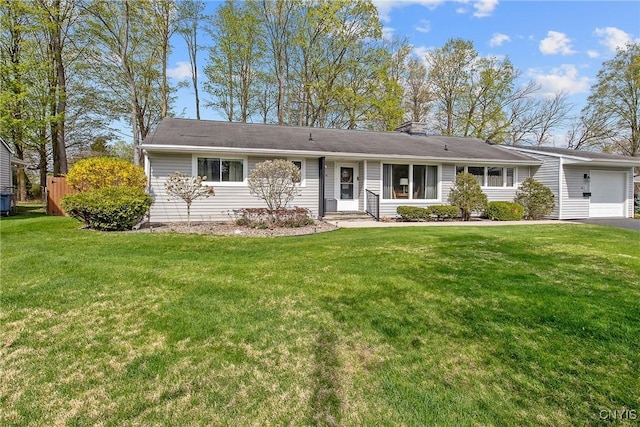 ranch-style home featuring a garage, a front lawn, aphalt driveway, and a chimney