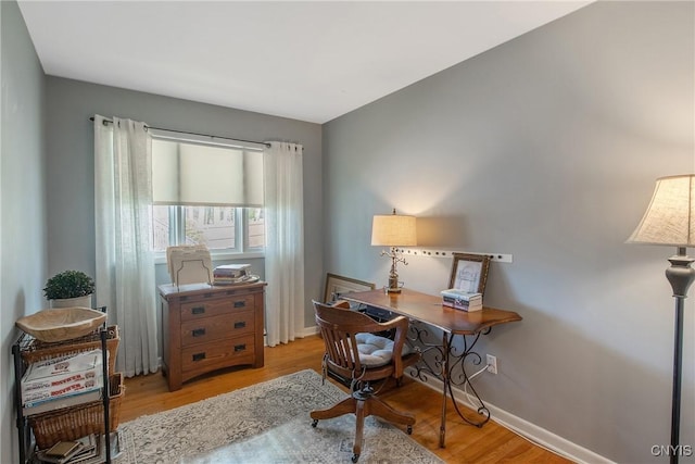 office space featuring baseboards and wood finished floors