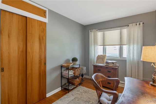 office area with baseboards and wood finished floors