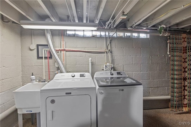 washroom with laundry area, a sink, and washer and clothes dryer