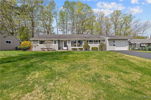 single story home with a garage, a front yard, and aphalt driveway