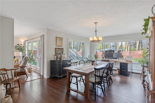dining space featuring dark wood-style floors, a baseboard radiator, and plenty of natural light
