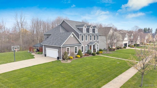 traditional-style house featuring a garage, roof with shingles, concrete driveway, and a front lawn