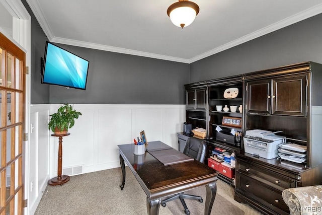 carpeted office space featuring ornamental molding, a wainscoted wall, and a decorative wall
