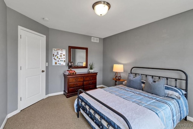 carpeted bedroom featuring visible vents and baseboards