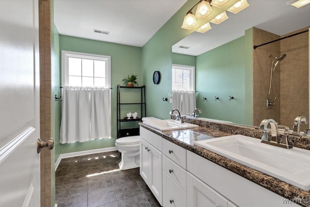 full bath with a sink, toilet, and visible vents